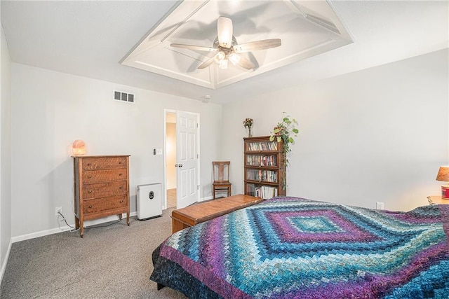 bedroom with visible vents, a raised ceiling, carpet floors, baseboards, and ceiling fan