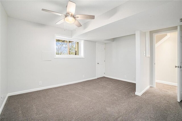 interior space featuring carpet, baseboards, and ceiling fan