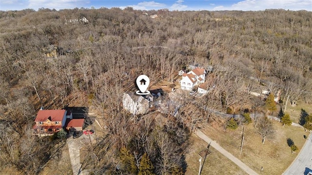 drone / aerial view featuring a wooded view