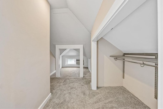 hall featuring light colored carpet and vaulted ceiling