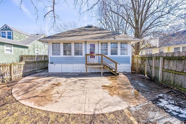 view of front of house with a fenced backyard and a patio