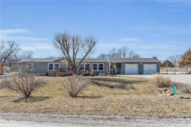 single story home featuring driveway, an attached garage, and fence