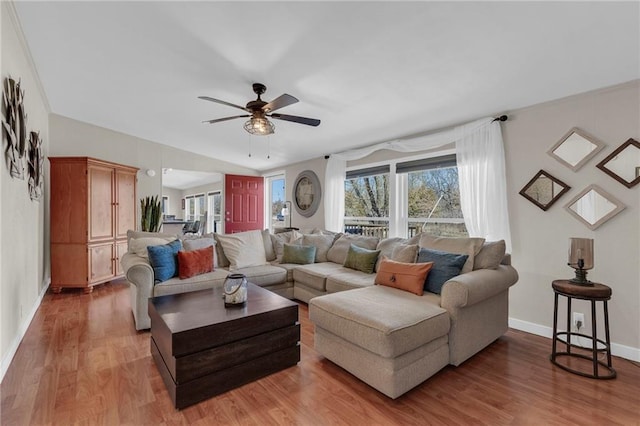 living room with ceiling fan, wood finished floors, and baseboards