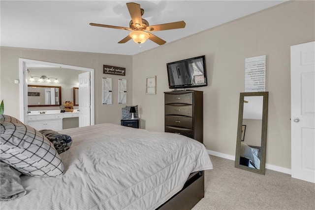 carpeted bedroom with a ceiling fan, baseboards, and connected bathroom