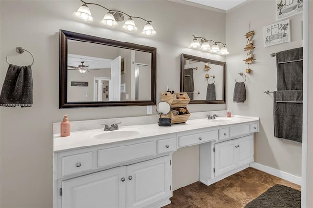 bathroom featuring double vanity, baseboards, and a sink