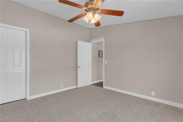 unfurnished bedroom featuring carpet, baseboards, and a ceiling fan