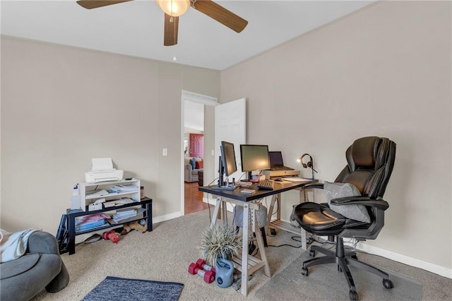 office space featuring a ceiling fan, carpet flooring, and baseboards