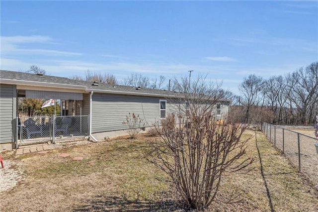 view of side of home featuring fence