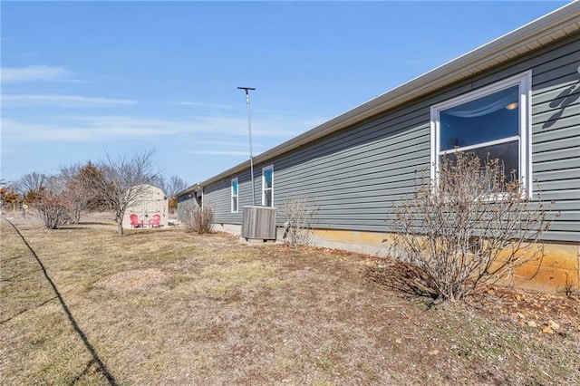 view of property exterior featuring a yard and central AC unit