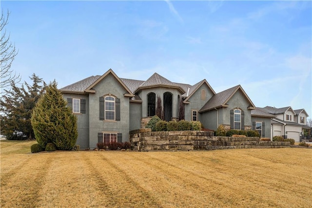 french provincial home with stucco siding, cooling unit, and a front yard