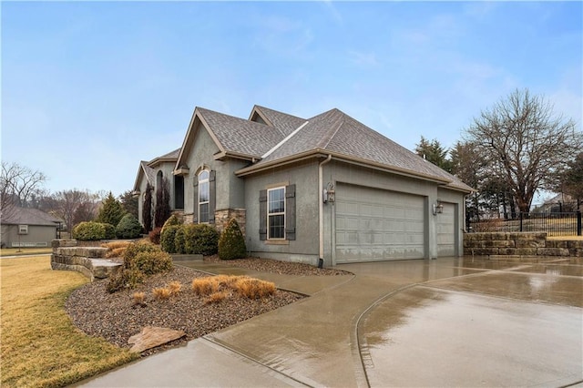 view of side of home featuring driveway, a garage, a shingled roof, fence, and stucco siding