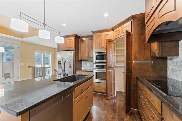 kitchen with custom exhaust hood, tasteful backsplash, appliances with stainless steel finishes, dark wood-type flooring, and a sink