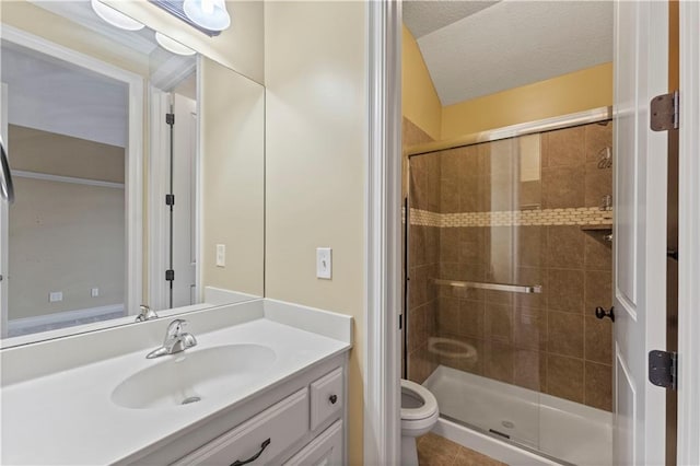 bathroom featuring toilet, a shower stall, a textured ceiling, and vanity