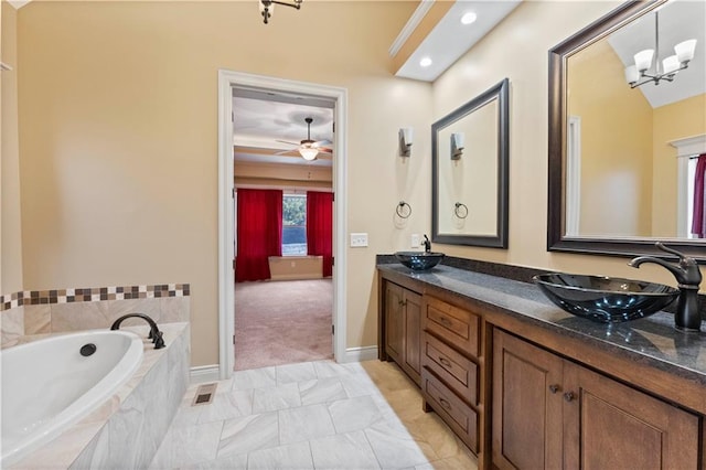 full bath with double vanity, a sink, and a bath