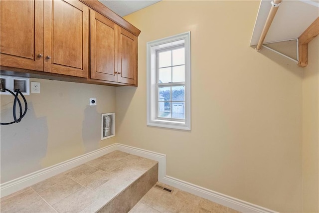 laundry room featuring hookup for a washing machine, cabinet space, visible vents, hookup for an electric dryer, and baseboards