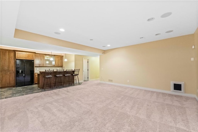 living room featuring baseboards, recessed lighting, bar area, and light colored carpet