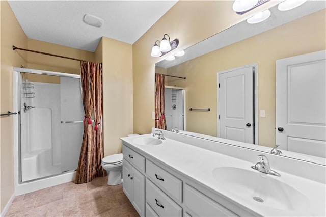 full bathroom with a stall shower, a sink, and toilet