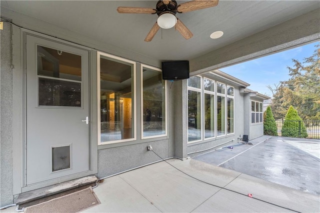 view of patio with fence and a ceiling fan