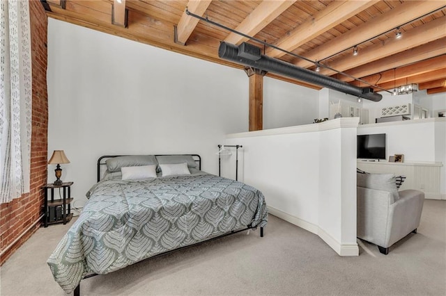 carpeted bedroom featuring brick wall, wooden ceiling, rail lighting, and beam ceiling