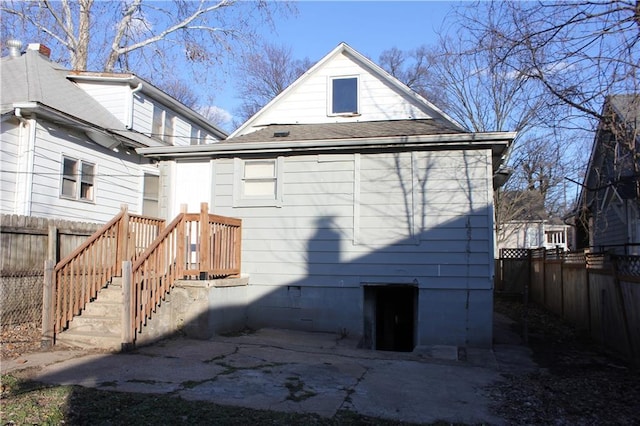 back of property featuring fence and a patio