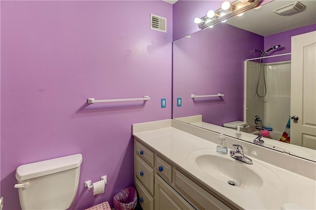 full bathroom featuring toilet, shower / bath combination, visible vents, and vanity