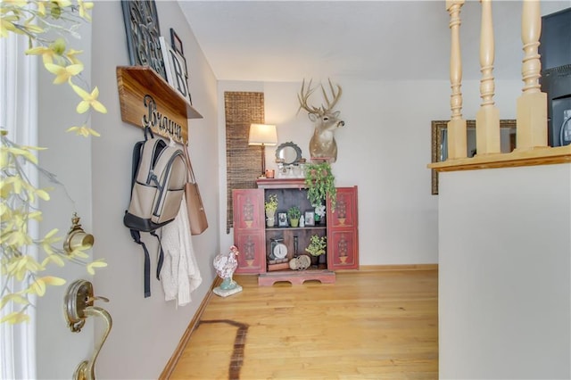 interior space with baseboards and wood finished floors