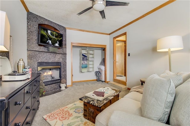 living area with ornamental molding, a large fireplace, light colored carpet, and a ceiling fan