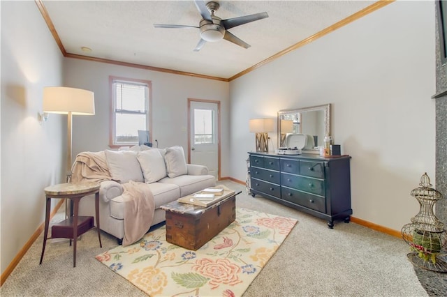 carpeted living room featuring ornamental molding, a ceiling fan, and baseboards