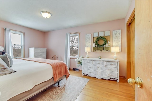 bedroom featuring light wood-style floors and multiple windows