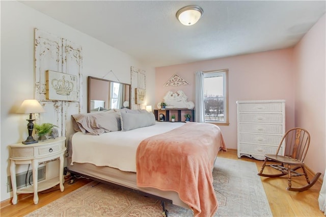 bedroom with wood finished floors and visible vents