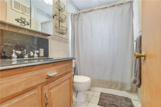 bathroom featuring a shower with shower curtain, vanity, toilet, and tile patterned floors