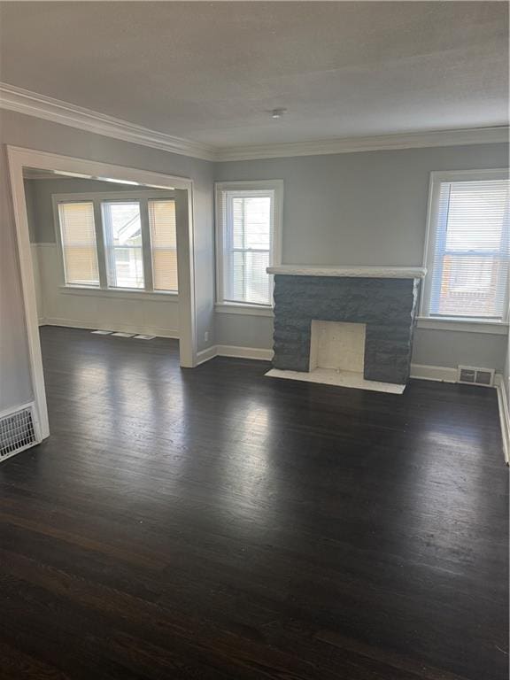 unfurnished living room featuring visible vents and crown molding