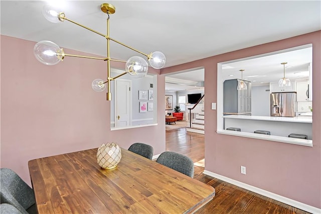 dining room with stairs, wood finished floors, and baseboards