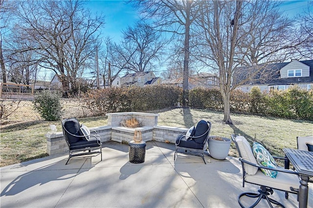 view of patio / terrace with an outdoor fire pit and fence