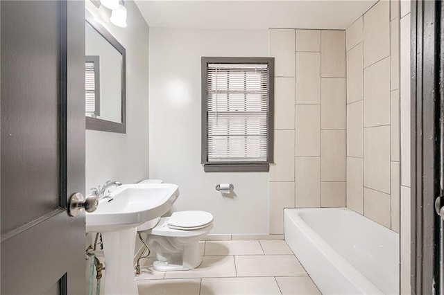 bathroom with tile patterned flooring, baseboards, and toilet