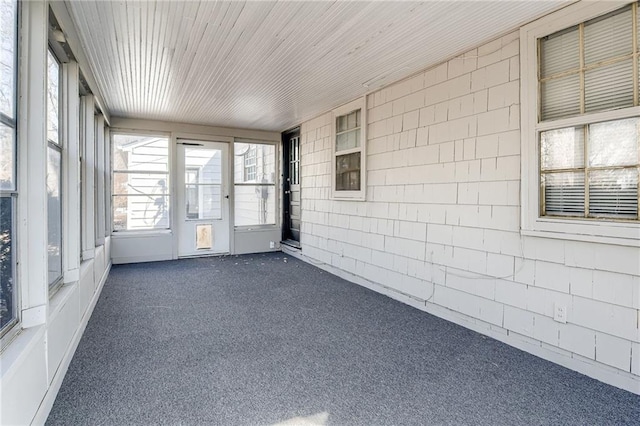 unfurnished sunroom featuring wood ceiling