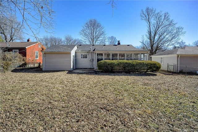 rear view of house featuring a lawn