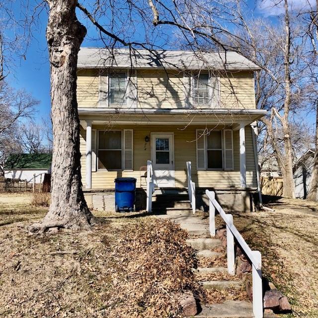 traditional-style home featuring a porch