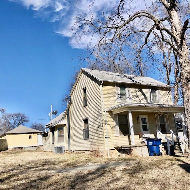 rear view of property with central air condition unit and a porch