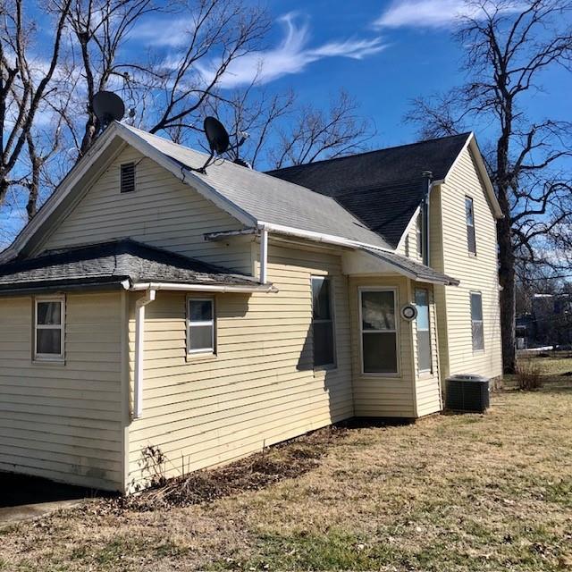 view of property exterior featuring a yard and cooling unit