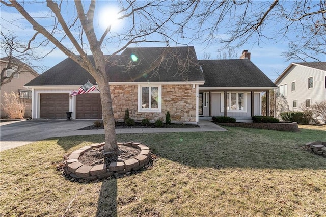 view of front of home with a shingled roof, a front yard, a chimney, a garage, and driveway