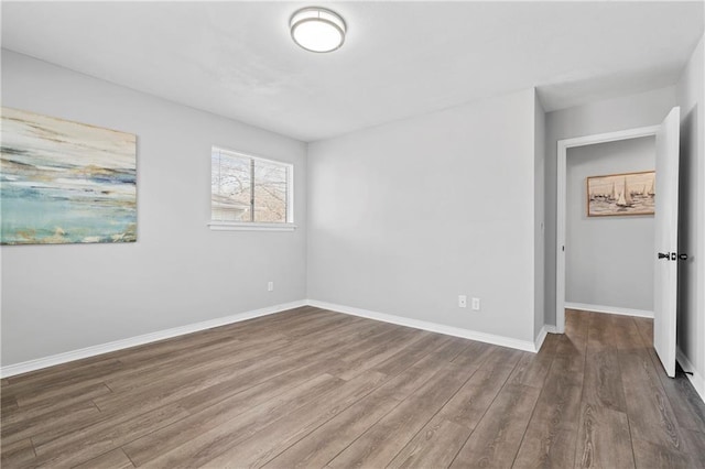 interior space with baseboards and wood finished floors