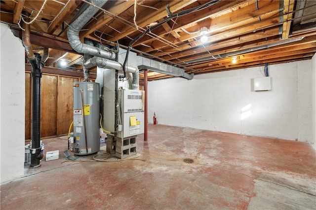 unfinished basement with water heater and heating unit