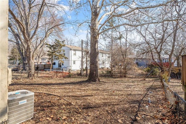 view of yard with cooling unit and fence