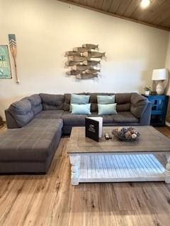 living area featuring wood ceiling, vaulted ceiling, and wood finished floors