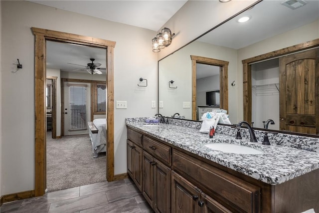 164 Dogwood Park Trl, Branson, MO 65616 - ensuite bathroom with double vanity, connected bathroom, a ceiling fan, and a sink