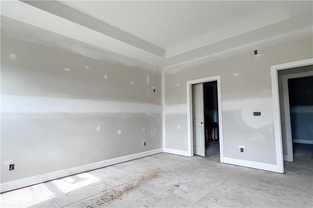 1107 Charles St, Knob Noster, MO 65336 - unfurnished bedroom with baseboards and a tray ceiling