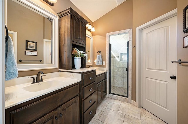 full bathroom with vaulted ceiling, a shower stall, and vanity