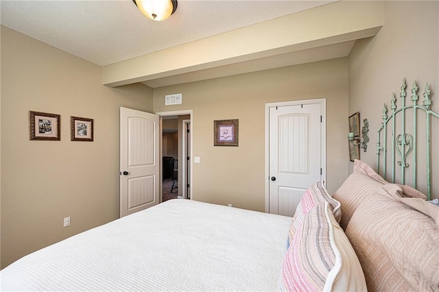 bedroom featuring beam ceiling