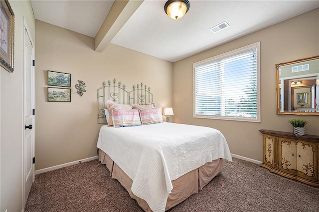 carpeted bedroom with beamed ceiling, visible vents, and baseboards